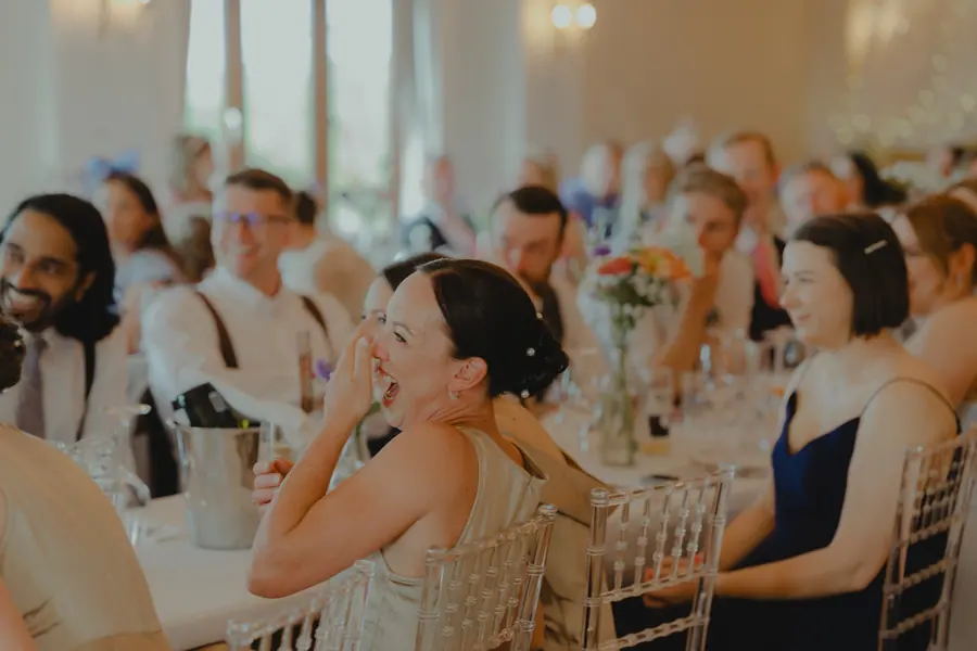 Guests seated along the flower-filled tables during dinner in the Hall