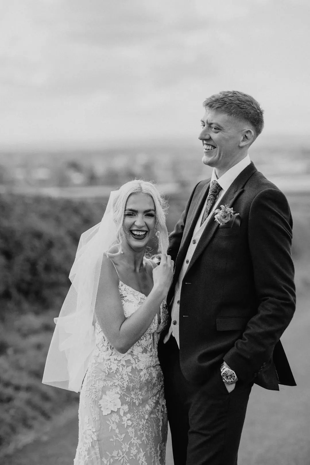 Jack and Harriet standing together in black and white against the fields