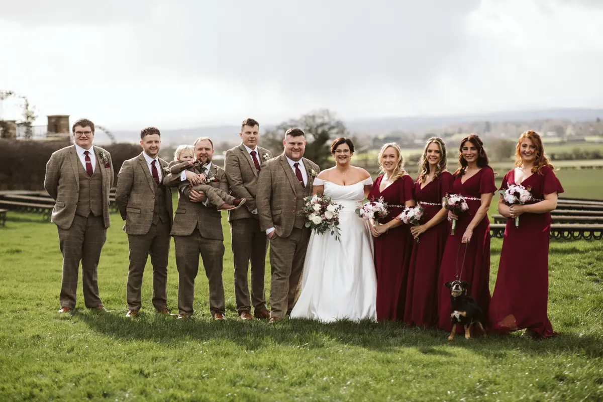 Katy and George with attendants in brown suits and burgundy dresses