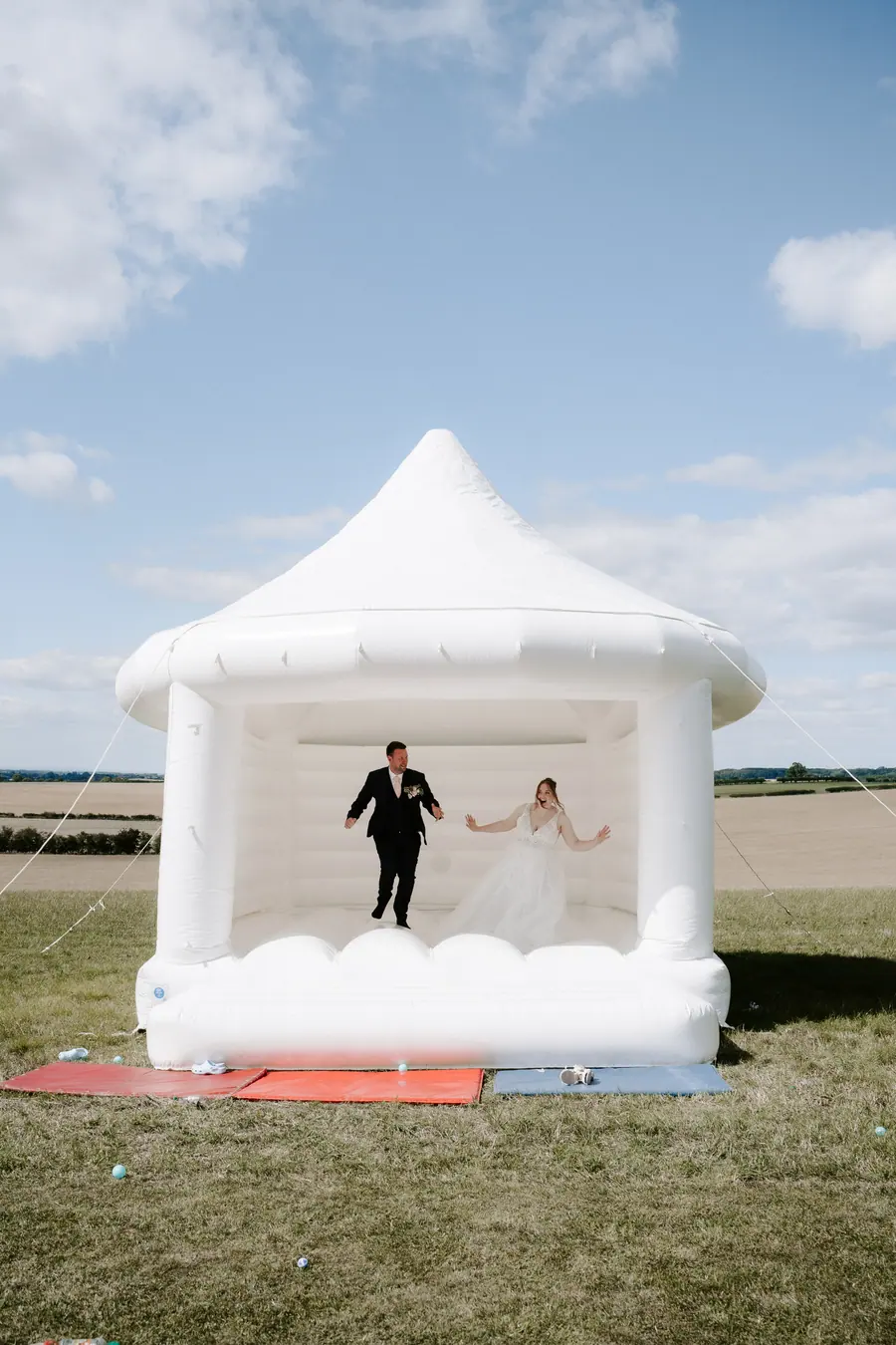 Laura and Marc standing inside a white inflatable structure in the field