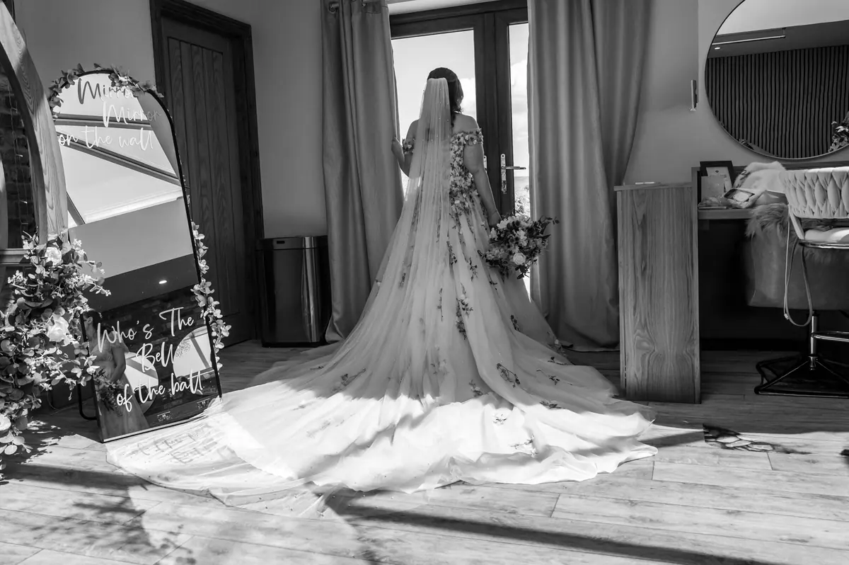 Megan's floral train spread across the preparation room floor in monochrome