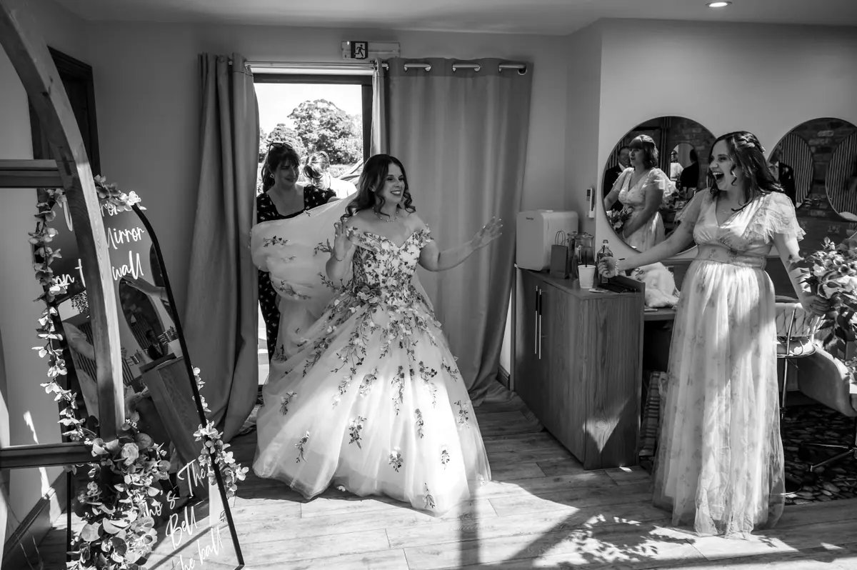 Megan entering the preparation room with women gathered around her
