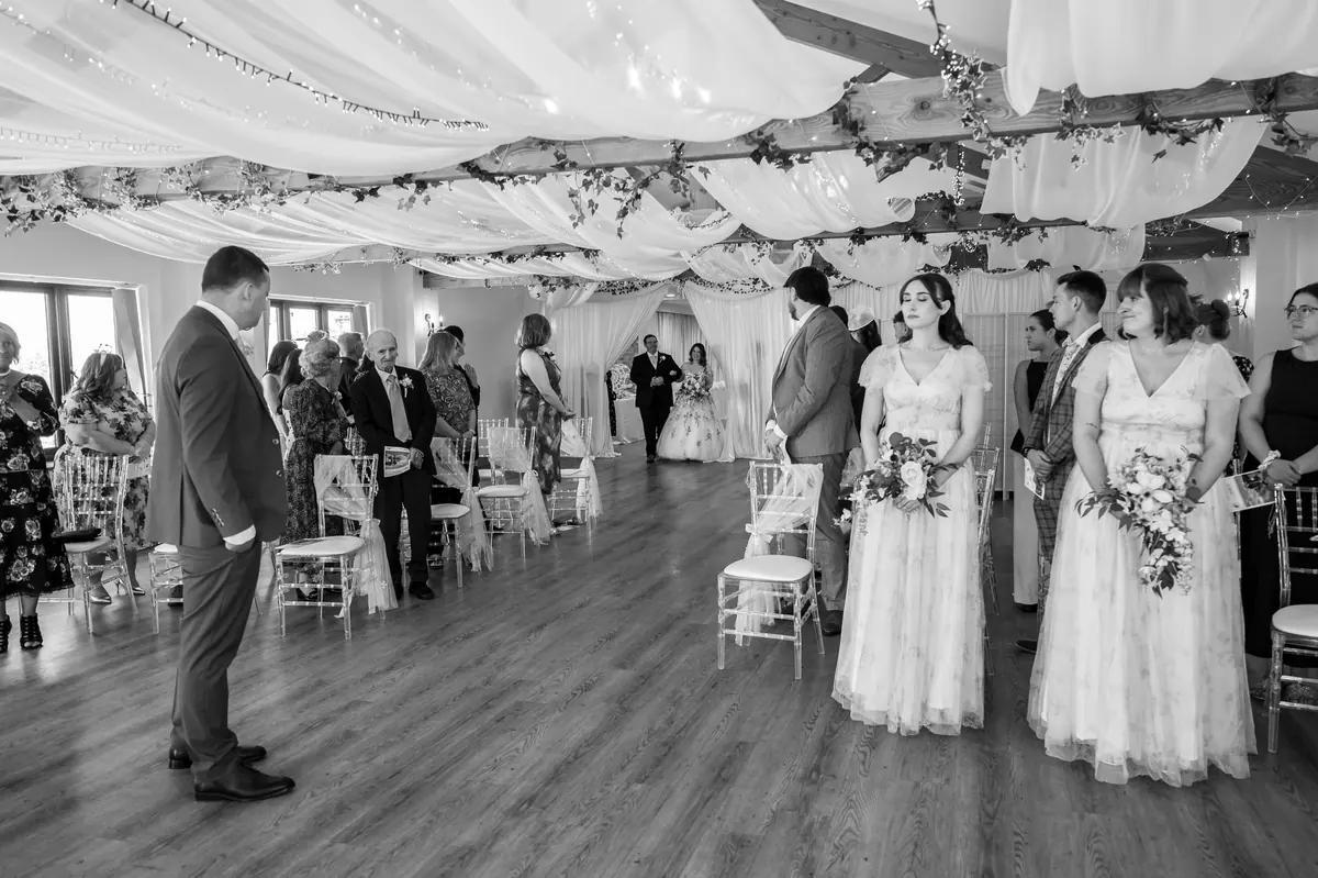 Guests standing for the indoor Hall ceremony in black and white