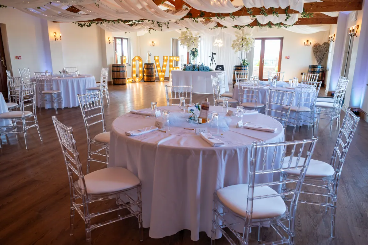 Round Hall table laid with blue flowers, glassware and pale stationery