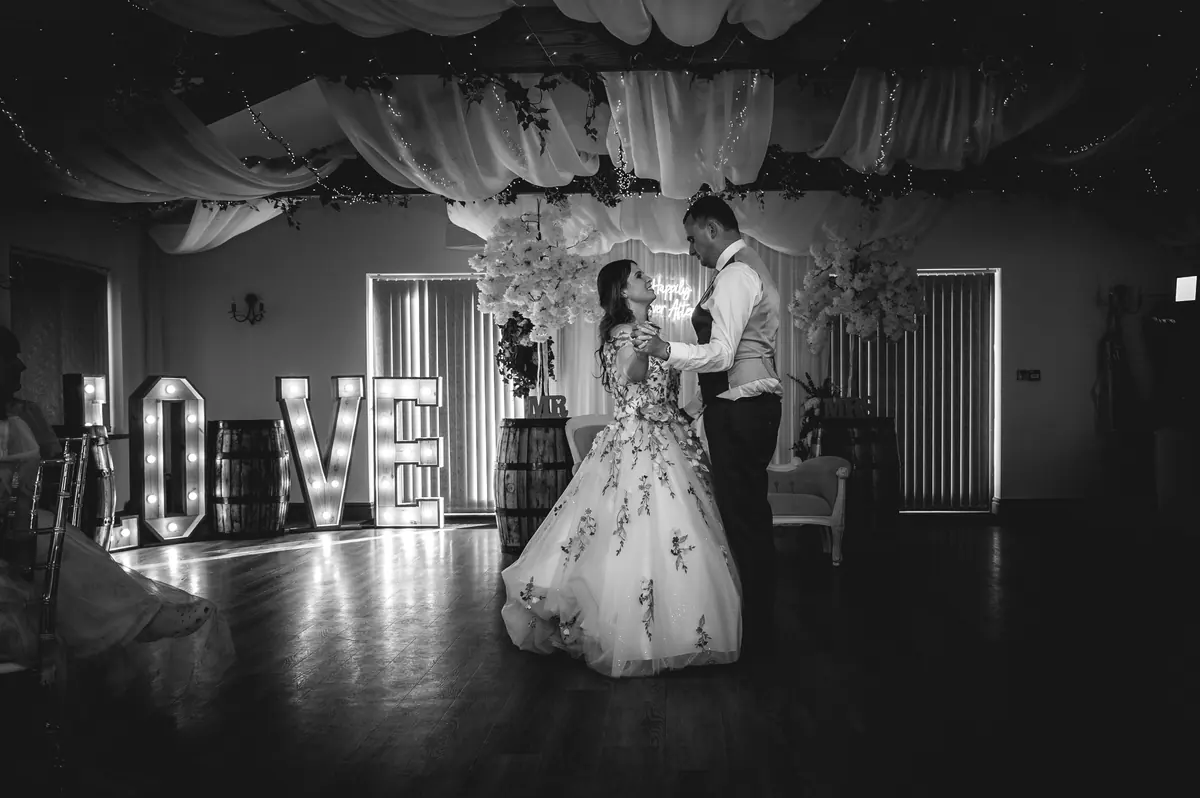 Megan and Dan dancing in the Hall in black and white