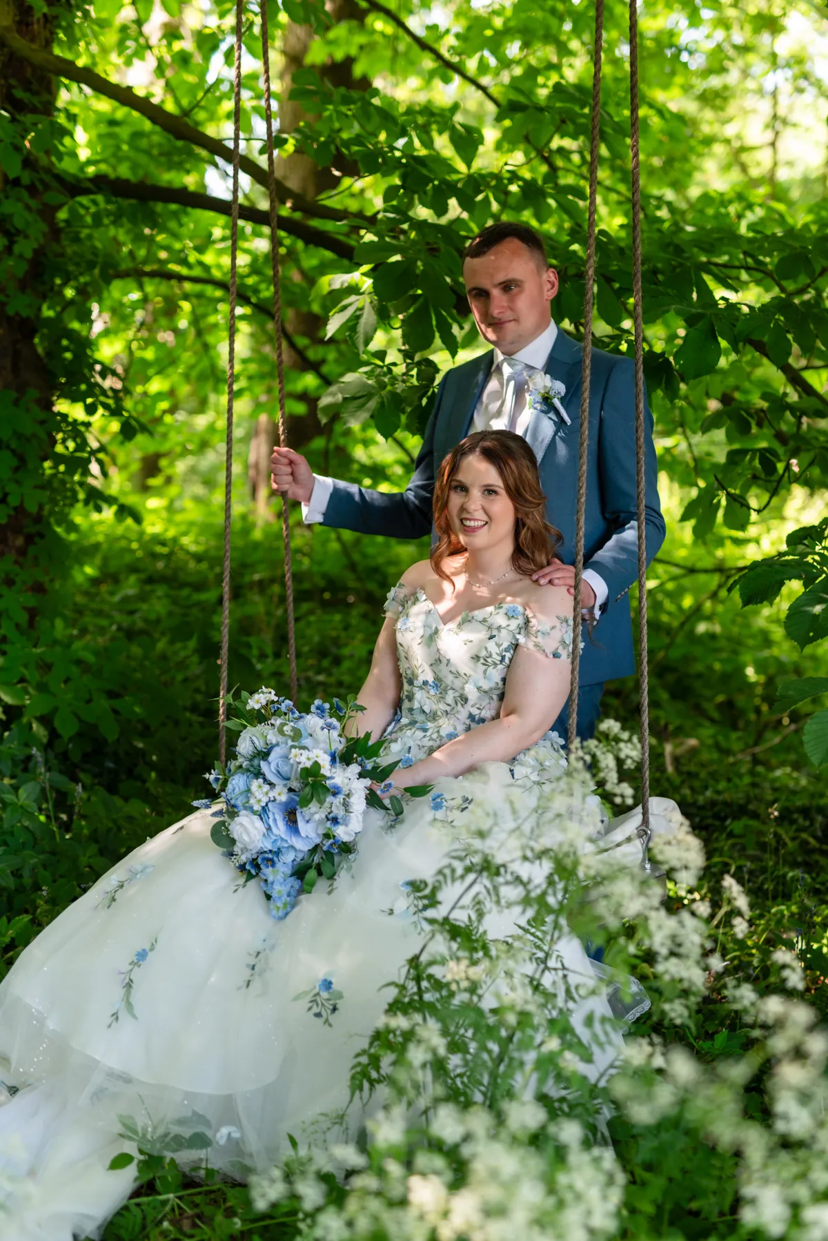 Megan and Dan together on a garden swing on their wedding day
