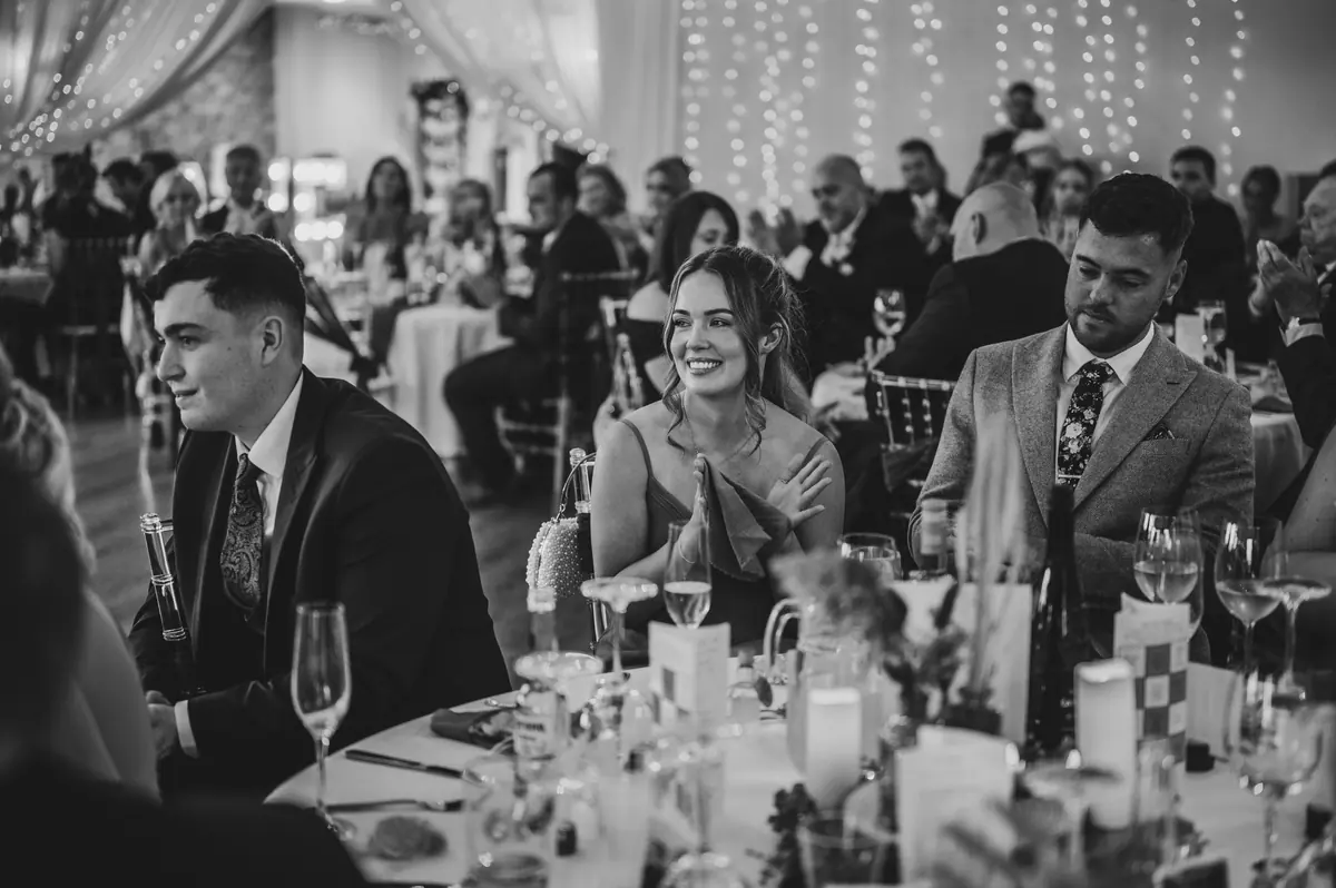 Guests gathered around tables in the Hall beneath a curtain of warm lights