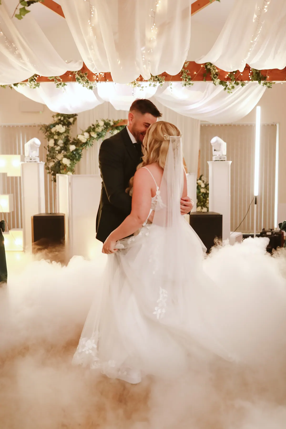 A couple sharing their first dance in low-lying fog at Thief Hall