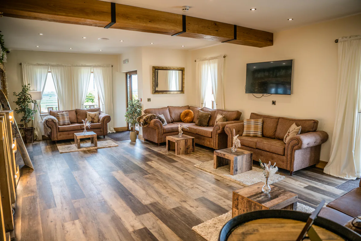 The Thief Hall lounge with leather sofas beneath exposed beams