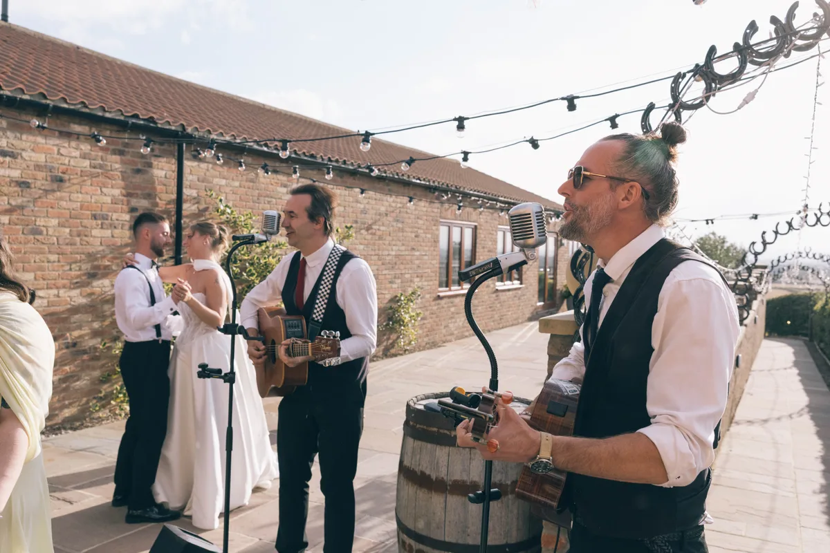 Guests enjoying drinks and live music in the courtyard