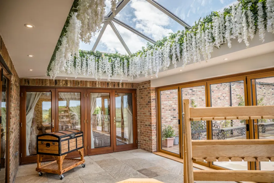 A light-filled room with wisteria beneath a glazed lantern roof