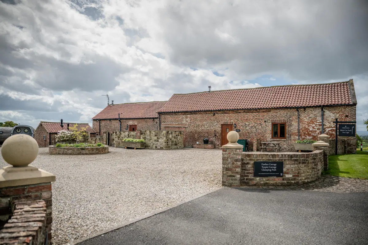 The brick cottage range and accommodation entrance at Thief Hall