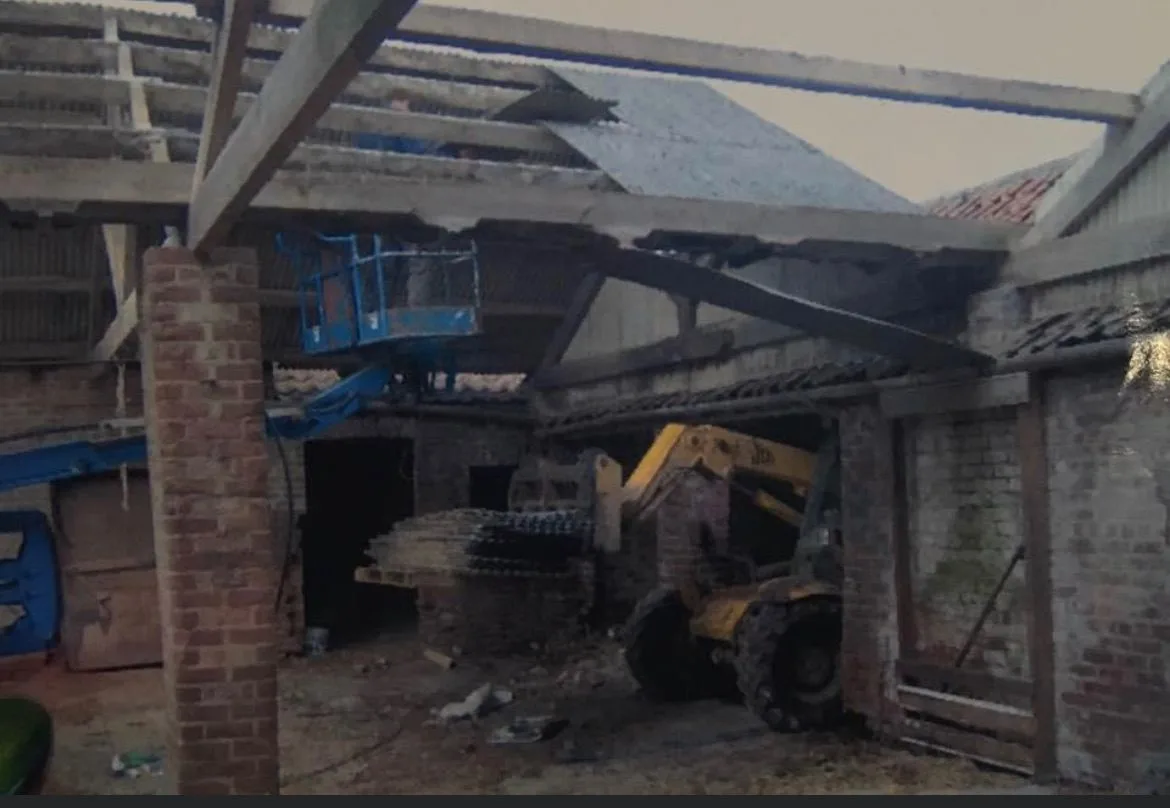 Brick farm buildings being opened up during the conversion work at Thief Hall